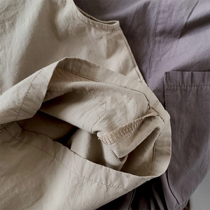 Detail of breathable cotton linen fabric with precise stitching for kids overalls