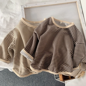 Close-up of striped kids long sleeve shirts showing cotton fabric and ribbed necklines