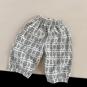 Detail of children's cotton linen pants featuring ethnic geometric prints and elastic waist