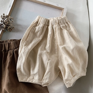 Close-up of linen-cotton kids harem shorts in beige and brown with natural fabric texture