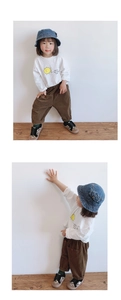 Close-up of kids corduroy casual pants with a white printed long-sleeve tee outfit