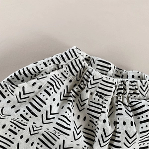 Close-up of baby linen harem pants elastic waistband with tribal geometric pattern print