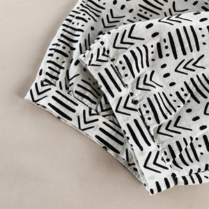 Close-up of black and white geometric print cotton linen fabric with fine stitching detail