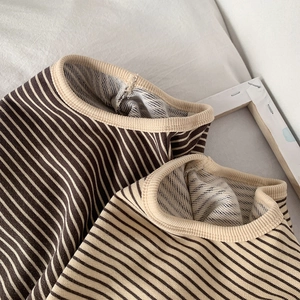 Close-up of striped long sleeve shirt with ribbed crew neck and soft loopback texture