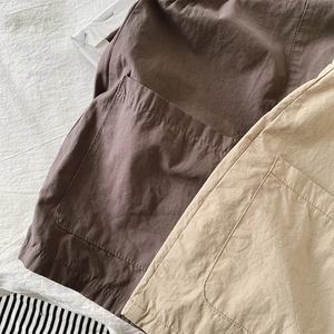 Detail of high-density cotton utility pockets with double-needle stitching on kids' trousers