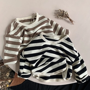 Detail of striped cotton long-sleeved t-shirts for kids in brown and black colors