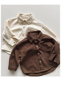 Detailed texture of cotton linen shirts for kids in beige and dark brown colors