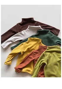 Detail view of colorful soft cotton kids long sleeve turtlenecks in Morandi tones