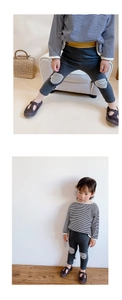 Detail of grey toddler leggings with stripe patches and striped long sleeve shirt