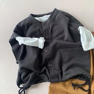 Detailed flat lay of a kids casual outfit set with a grey shirt and mustard yellow pants