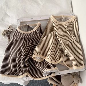Detail of kids striped long sleeve shirts with knit cotton texture and contrast binding