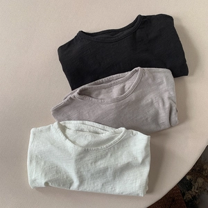 Three stacked slub cotton long sleeve T-shirts in black, taupe, and cream beige colors