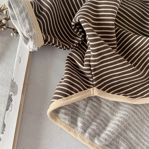 Detailed macro view showing soft striped loopback fabric texture and ribbed neck trim