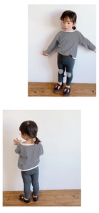 Detail of girls' striped long-sleeve tee and grey trousers with knee patches
