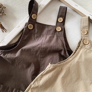 Detailed macro view of cotton linen fabric texture and wooden buttons on kids overalls