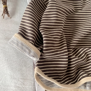 Detail showing soft terry lining and striped cuffs of this kids cotton long sleeve shirt
