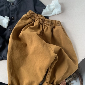 Flat lay of mustard yellow cotton kids casual pants with elastic waist in Japanese style