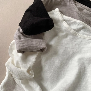 Close-up of slub cotton texture on basic long sleeve T-shirts for kids in neutral colors