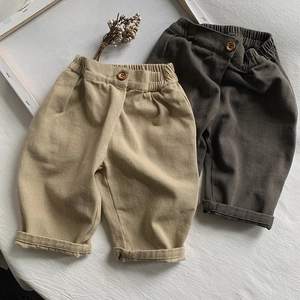 Flat lay of khaki and dark grey loose-fitting kids cotton trousers with elastic waist