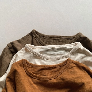 Detailed close-up showing the soft slub cotton fabric texture of kids' long sleeve shirts