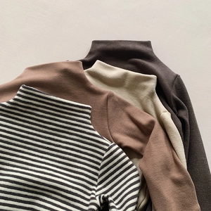 Detail of warm kids' mock neck tops in striped, brown, beige, and coffee soft fabrics