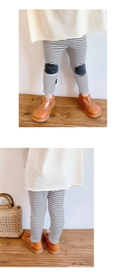 Detail of girls striped leggings with knee patches and retro brown leather shoes