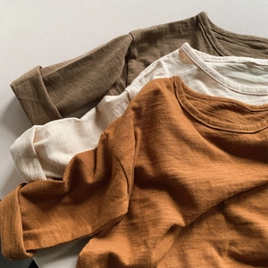 Detailed macro view of bamboo cotton fabric texture on long sleeve kids t-shirts