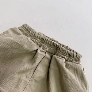 Close-up of elastic waistband and khaki cotton twill fabric on children casual pants