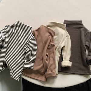 Close-up of four kids' mock neck thermal tops showing ribbed texture in neutral colors