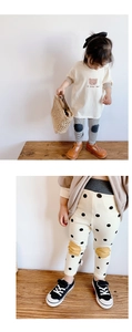 Close-up of cotton leggings with knee patches in striped and polka dot patterns