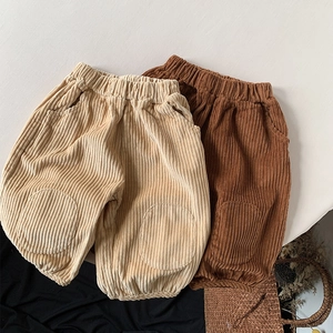 Detail of children's corduroy trousers with elastic waistband and round knee patches