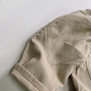 Detail shot of khaki twill cotton fabric with high-quality stitching and rolled hem