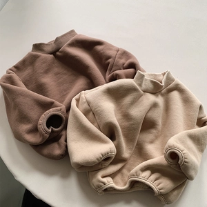 Detailed close-up of thick fleece sweatshirts with ribbed cuffs in warm earth tones