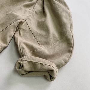 Kids khaki wide-leg cotton pants featuring folded cuffs and detailed twill texture