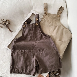Minimalist cotton overalls for kids with wooden buttons and front pocket in two colors