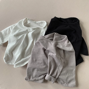 Flat lay of three soft cotton long sleeve shirts in white black and grey for kids