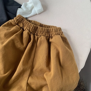 Detail of kids loose-fit mustard yellow casual pants with comfortable elastic waistband