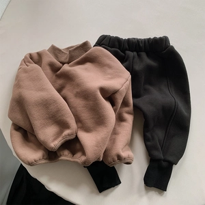 Detailed flat lay of children thick fleece sweatshirt set with ribbed cuffs and joggers