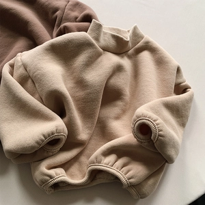 Detail view of thickened fleece kid's sweatshirt showing ribbed collar and sleeve cuffs