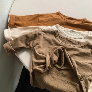 Detail showing the bamboo cotton texture of children long sleeve basic t-shirts in earth tones