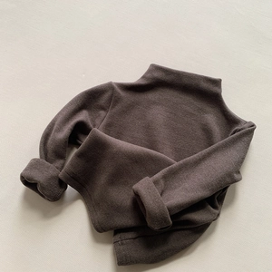 Detailed texture of dark coffee kids thermal turtleneck sweater with soft brushed fabric