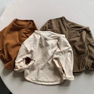 Detailed macro view showing bamboo cotton fabric texture and earth tone long sleeve t-shirts