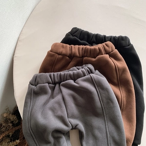 Flat lay of kids thermal fleece joggers in black, brown, and grey with elastic waistbands