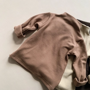 Detailed view of kids thermal turtleneck shirt in brown with soft fleece texture