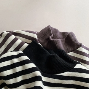 Detail view of striped fleece sweatshirts showing ribbed necklines and soft knit texture