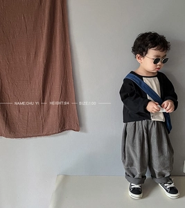 Kids streetwear style featuring loose gray harem pants and black long sleeve t-shirt