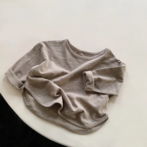Detail view of slub cotton long sleeve kids T-shirt with curved hem and soft texture