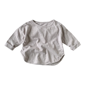 Kids long sleeve slub cotton tee with a curved hem and ribbed texture in light grey