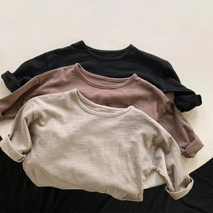 Detailed view of three cotton long sleeve shirts in black, tan and beige colors