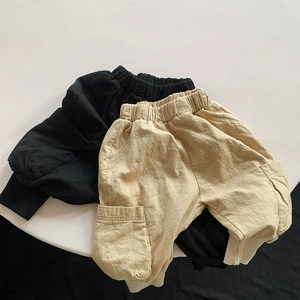 Flat lay of double-layered cotton kids cargo pants featuring elastic waist and large side pockets